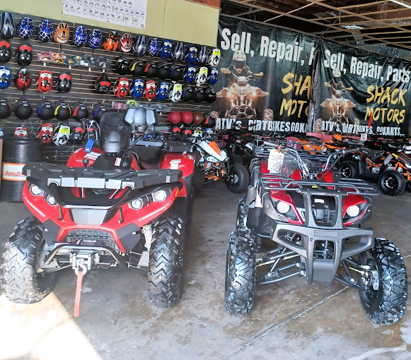 A couple of atvs parked inside of a building