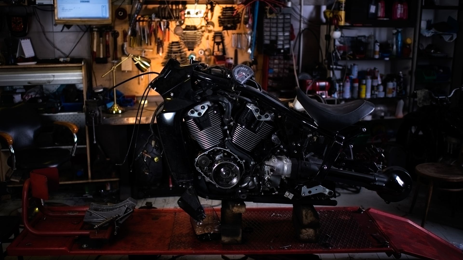 A motorcycle sitting on top of a table in a garage