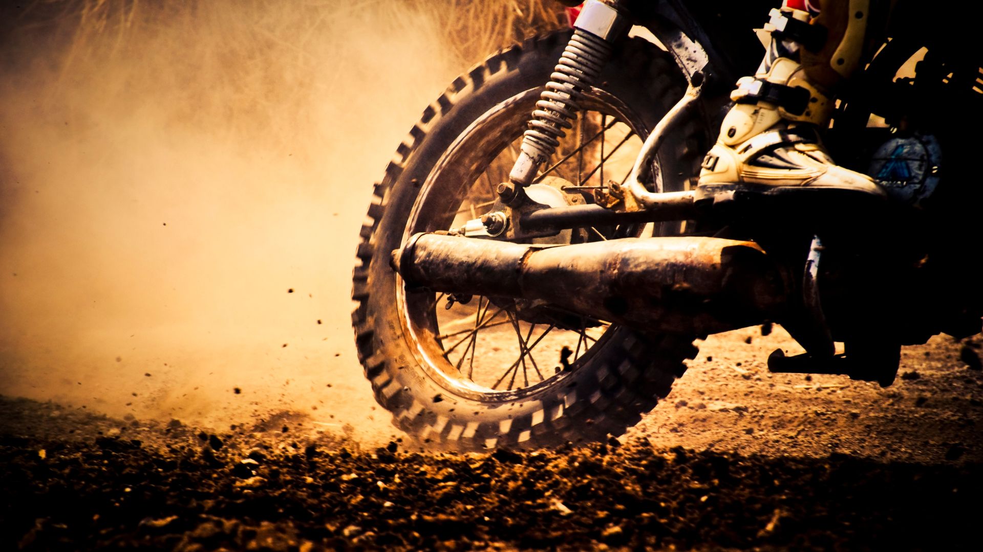 A dirt bike riding on a dirt road